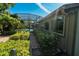 View of the enclosed pool from a landscaped brick path surrounded by lush vegetation at 5016 Fawn Ridge Rd, Orlando, FL 32819