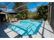 Inviting screened-in pool with dining area, surrounded by well-maintained tile flooring and lush greenery at 5016 Fawn Ridge Rd, Orlando, FL 32819