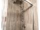 Close-up of modern shower fixtures with sleek gray tile and sliding glass door at 5016 Fawn Ridge Rd, Orlando, FL 32819