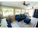Bright and airy sunroom with large windows, comfortable seating, and views of the lush backyard at 5016 Fawn Ridge Rd, Orlando, FL 32819