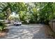 Expansive gravel backyard featuring ample parking, complete with mature trees, a utility shed and a patio at 520 E Anderson St, Orlando, FL 32801