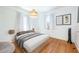 Bright bedroom with hardwood floors, white walls, natural light, and stylish decor for a serene and inviting atmosphere at 520 E Anderson St, Orlando, FL 32801