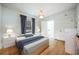Bright bedroom features hardwood floors, natural light, and simple furnishings, creating a comfortable and inviting atmosphere at 520 E Anderson St, Orlando, FL 32801