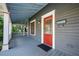 Cozy front porch with a red front door, offering a welcoming entrance to the home at 520 E Anderson St, Orlando, FL 32801