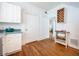 Cozy kitchen featuring white cabinets, hardwood floors, and modern appliances at 520 E Anderson St, Orlando, FL 32801