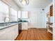 Well-lit kitchen with white cabinets, black appliances, and hardwood flooring at 520 E Anderson St, Orlando, FL 32801
