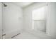 All-white tiled shower with a rainfall showerhead, a linear drain and a window providing natural light at 520 E Anderson St, Orlando, FL 32801