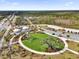 Community green space with walking paths, parking and tented amenity buildings in developing neighborhood at 6403 Cyrils Dr, St Cloud, FL 34771