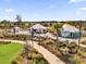 Community center with tented buildings, patio furniture, landscaping and path ways in a Gathering neighborhood at 6403 Cyrils Dr, St Cloud, FL 34771