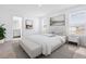 Bright bedroom featuring a white color scheme, two windows, and an ensuite bathroom at 6403 Cyrils Dr, St Cloud, FL 34771