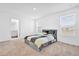 Clean bedroom featuring an ensuite bathroom, neutral colors, and a large window at 6403 Cyrils Dr, St Cloud, FL 34771