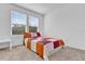 Bedroom featuring two windows, neutral carpeting, and comfortable interior at 6403 Cyrils Dr, St Cloud, FL 34771