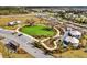 Aerial view of community park, parking, walking paths and tented buildings surrounded by residential homes at 6403 Cyrils Dr, St Cloud, FL 34771