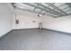 Spacious two-car garage with sealed epoxy floor and modern lighting at 6403 Cyrils Dr, St Cloud, FL 34771