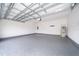 Spacious two-car garage with sealed epoxy floor and modern lighting at 6403 Cyrils Dr, St Cloud, FL 34771
