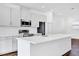 Well-lit kitchen features white cabinets, stainless steel appliances, and a large center island at 6403 Cyrils Dr, St Cloud, FL 34771