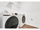 Modern laundry room features a Samsung washer and dryer, with shelving for organized storage at 6403 Cyrils Dr, St Cloud, FL 34771