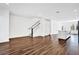 Spacious living room with wood floors and staircase, connecting the home's floors at 6403 Cyrils Dr, St Cloud, FL 34771