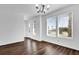 Bright and airy living room with hardwood floors, large windows, and a modern chandelier at 6403 Cyrils Dr, St Cloud, FL 34771