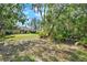Expansive backyard with mature trees and natural landscape, creating a private and serene outdoor retreat at 873 Gulf Land Dr, Apopka, FL 32712