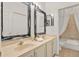 Bathroom with a double vanity featuring framed mirrors and modern fixtures in a well-lit space at 873 Gulf Land Dr, Apopka, FL 32712