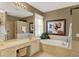 Well-lit bathroom with vanity, bathtub, framed mirror, and tiled floors at 873 Gulf Land Dr, Apopka, FL 32712