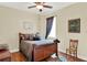 Bedroom with a wood-framed bed, ceiling fan, and natural light, creating a cozy and inviting atmosphere at 873 Gulf Land Dr, Apopka, FL 32712