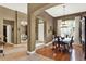 Elegant dining room with hardwood floors, arched doorway, and plenty of natural light at 873 Gulf Land Dr, Apopka, FL 32712