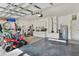 Spacious garage featuring ample storage, a lawnmower, and garage door openers, suitable for multiple vehicles at 873 Gulf Land Dr, Apopka, FL 32712