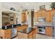 Well-lit kitchen with a kitchen island, stainless steel appliances, and granite countertops at 873 Gulf Land Dr, Apopka, FL 32712