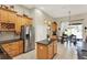 Spacious kitchen with stainless steel appliances, island, and an adjacent dining area at 873 Gulf Land Dr, Apopka, FL 32712