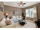 Comfortable living room featuring a large window, plush seating, and stylish decor at 873 Gulf Land Dr, Apopka, FL 32712