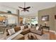 Bright and airy living room with a comfortable sectional sofa and access to the backyard at 873 Gulf Land Dr, Apopka, FL 32712