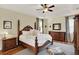 Bright bedroom featuring neutral colors, hardwood floors, and an ensuite bath at 873 Gulf Land Dr, Apopka, FL 32712