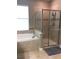 Elegant bathroom featuring a soaking tub and glass-enclosed shower, offering a spa-like experience in the comfort of home at 8950 Azalea Sands Ln # 8950, Champions Gate, FL 33896