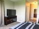 Comfortable bedroom with a mounted flatscreen TV, plush carpet, and neutral wall color at 8950 Azalea Sands Ln # 8950, Champions Gate, FL 33896