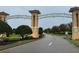 Inviting entrance to Champions Gate with lush landscaping and well-maintained roadway for an upscale community feel at 8950 Azalea Sands Ln # 8950, Champions Gate, FL 33896