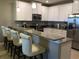 Well-appointed kitchen with granite countertops, modern appliances, and stylish bar seating, ideal for casual dining at 8950 Azalea Sands Ln # 8950, Champions Gate, FL 33896