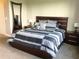 Serene main bedroom with a large bed, stylish bedding, and tasteful decor, creating a relaxing retreat for homeowners at 8950 Azalea Sands Ln # 8950, Champions Gate, FL 33896