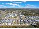 Aerial view of a well-planned community featuring numerous homes, green spaces and a tranquil lake at 896 Tilden Oaks Trl, Winter Garden, FL 34787