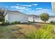 Beautiful backyard with a well-kept lawn, landscaping, and detached garage at 896 Tilden Oaks Trl, Winter Garden, FL 34787
