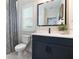 Chic bathroom features a vanity with a dark blue cabinet and elegant fixtures at 896 Tilden Oaks Trl, Winter Garden, FL 34787