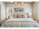 Inviting bedroom with a comfortable bed, decorative pillows, and bedside tables at 896 Tilden Oaks Trl, Winter Garden, FL 34787