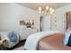 Bright bedroom with a plush chair, dresser, and contemporary decor at 896 Tilden Oaks Trl, Winter Garden, FL 34787