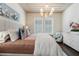 Elegant bedroom with a tufted headboard, stylish chandelier, and chic decor at 896 Tilden Oaks Trl, Winter Garden, FL 34787