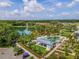 An aerial view of a community pool and recreation area with a lake, lush landscaping and walking trails at 896 Tilden Oaks Trl, Winter Garden, FL 34787