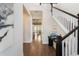 Bright foyer with wooden floors leading to a dining area and a staircase with black wood trim at 896 Tilden Oaks Trl, Winter Garden, FL 34787