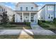 Charming two-story home with a welcoming front porch, landscaped yard and well-maintained lawn at 896 Tilden Oaks Trl, Winter Garden, FL 34787