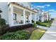A two-story house with inviting front porch with stylish seating and well-maintained landscaping at 896 Tilden Oaks Trl, Winter Garden, FL 34787
