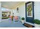 Charming front porch with cozy seating and a welcoming wreath on the front door at 896 Tilden Oaks Trl, Winter Garden, FL 34787